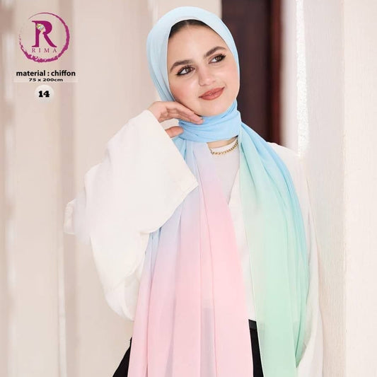 A woman wearing a lightweight chiffon hijab with a pastel gradient transition from light blue to pink, peach, and mint green. She is also wearing a white blouse and black pants, standing against a soft beige background with promotional text overlays.