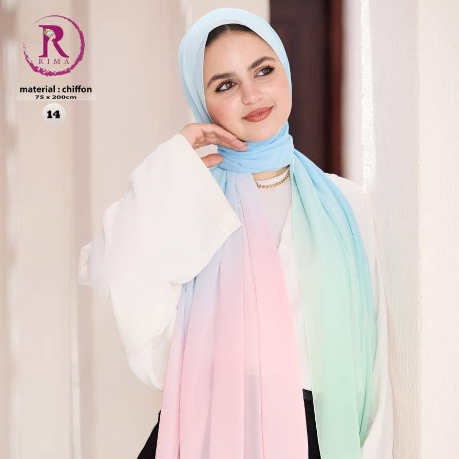 A woman wearing a lightweight chiffon hijab with a pastel gradient transition from light blue to pink, peach, and mint green. She is also wearing a white blouse and black pants, standing against a soft beige background with promotional text overlays.
